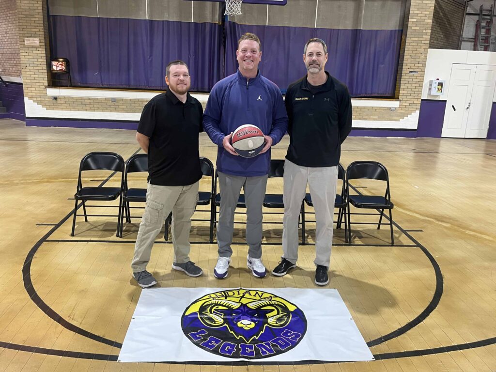 The team coaches of the Indiana Legends basketball team posing for photos